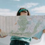 A woman looking at her map as she planes her gluten-free travel route.
