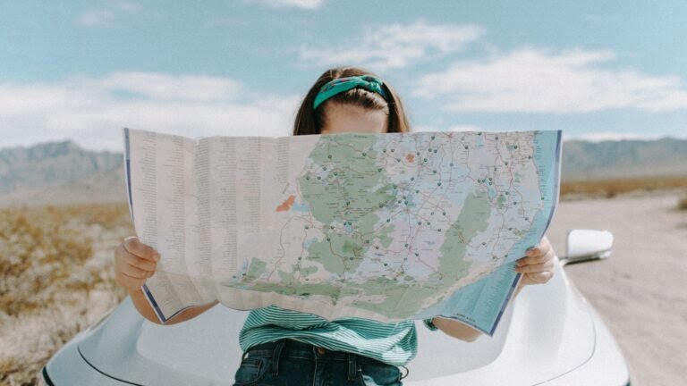 A woman looking at her map as she planes her gluten-free travel route.